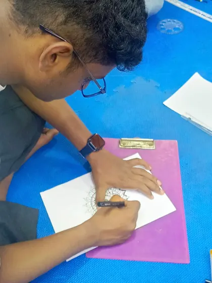 A close-up of a student working on the outer layers of his mandala. This is where the design really starts to expand and take on a life of its own.