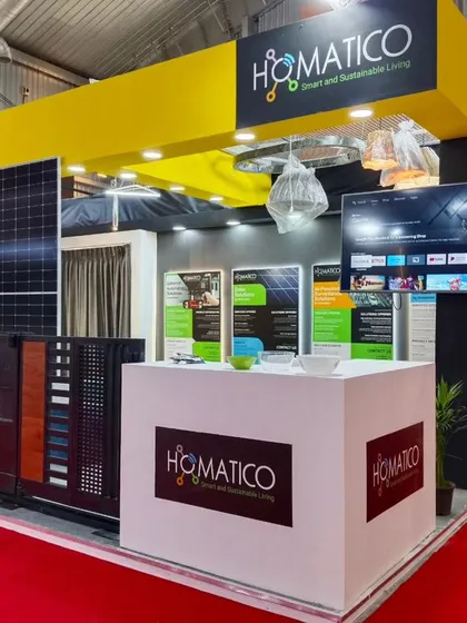 A clear shot of my exhibition booth, displaying our branding and key service areas like solar, entrance automation, and home automation.