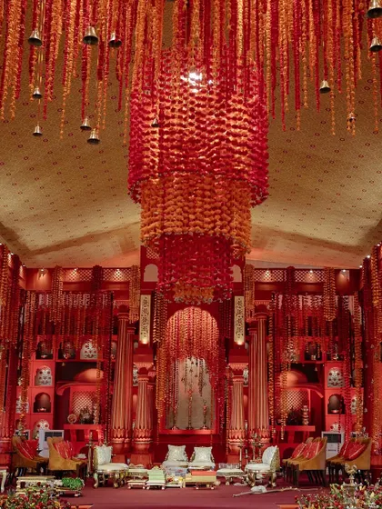 A look back at the grandeur of our 'Lal Bagh' creation. The sheer density of the red floral decor, from the hanging installations to the massive chandelier, demonstrates our commitment to creating immersive, awe-inspiring environments.