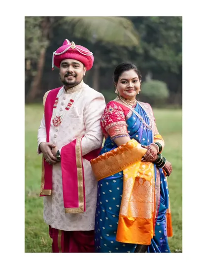 A classic back-to-back pose, showcasing the couple's elegant traditional outfits.