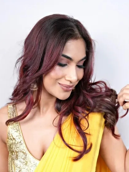 A closer look at the ruby waves, showing the interplay of different red shades that add depth and texture to the hair.