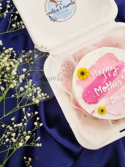 A simple and sweet "Happy Mother's Day" bento cake. This one has a painted brushstroke effect in pink and is decorated with little fondant sunflowers.