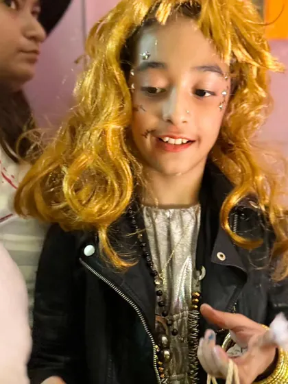 This rockstar character, with face gems and layered necklaces, perfectly embodies the fun and creative spirit of our parties.