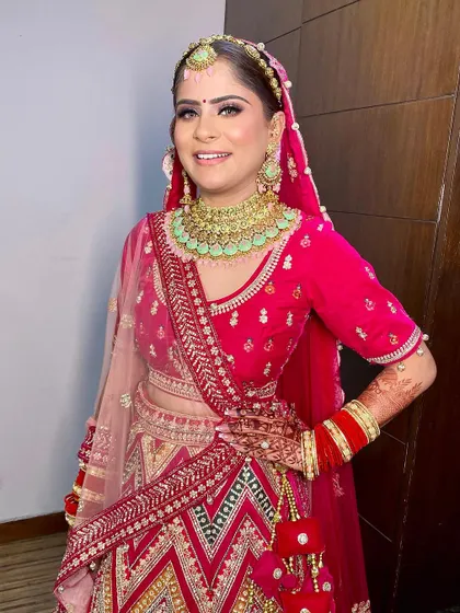 A beautiful bridal look for the sweet Gunjan. We paired her vibrant pink lehenga with a fresh, dewy makeup look and a sleek hairstyle.