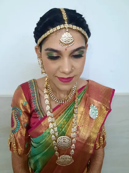 A close-up of the bride's Varapooja makeup, highlighting the precise application of the green shimmer eyeshadow and the rich lip color.