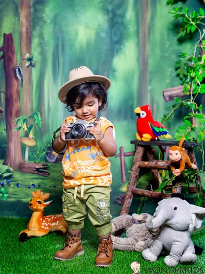 This little explorer is ready to take some pictures of his own. Using props that kids can interact with, like this toy camera, is a great way to capture their curiosity.