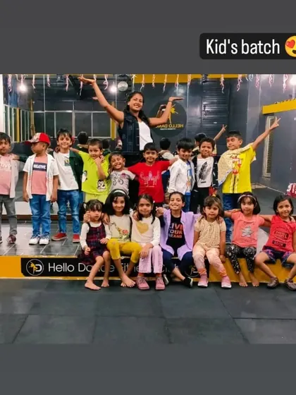 A proud group photo of our kids' batch with their instructor on the studio stage. This is where they practice for their big performances.