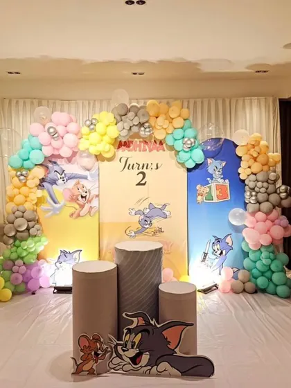 A classic Tom & Jerry theme for a 2nd birthday. We used pastel-colored balloon garlands and a custom backdrop featuring the iconic cartoon characters.