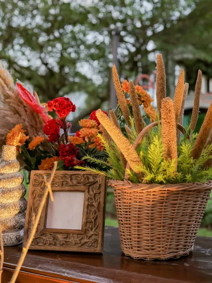 A rustic centerpiece featuring a basket of millet sprays, adding an unexpected and earthy texture to the decor.