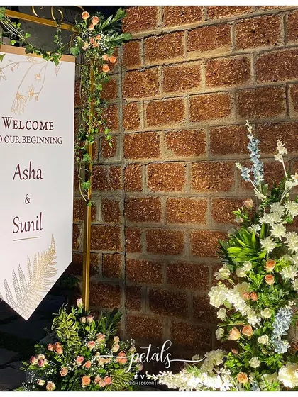 Another view of the captivating broken arch, with its beautiful blend of white and pastel flowers against a rustic brick wall.