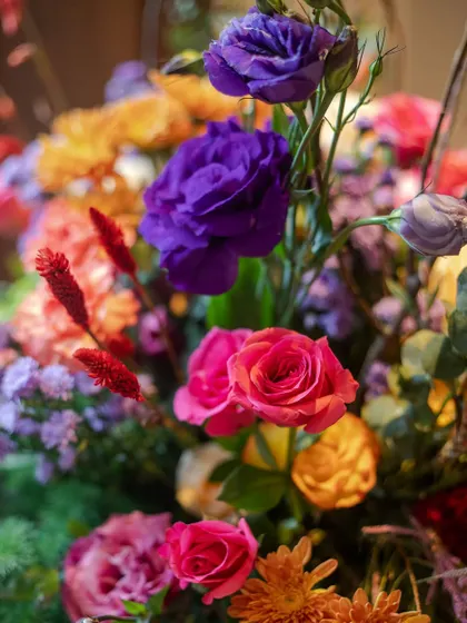 A macro shot of the floral arrangement, focusing on the intense colors of the purple lisianthus and pink roses. This highlights the quality and freshness of the blooms we use.