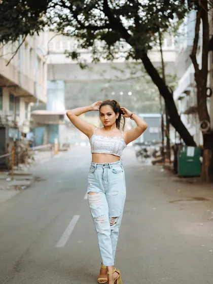 A full-length shot of a model walking down an empty street. This captures a sense of movement and style, perfect for a fashion editorial.