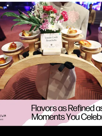 "Flavors as Refined as the Moments You Celebrate." A server presents Tomato Confit Bruschetta on a unique, multi-level wooden tray, showcasing our innovative approach to both food and service.