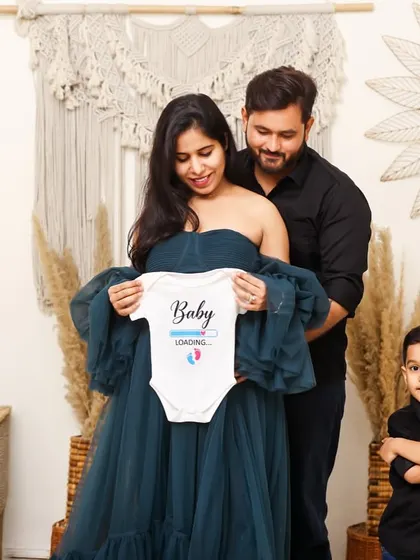 A heartwarming studio family portrait announcing a new arrival, with the big brother-to-be standing proudly. This shows how I include the entire family in the maternity journey.