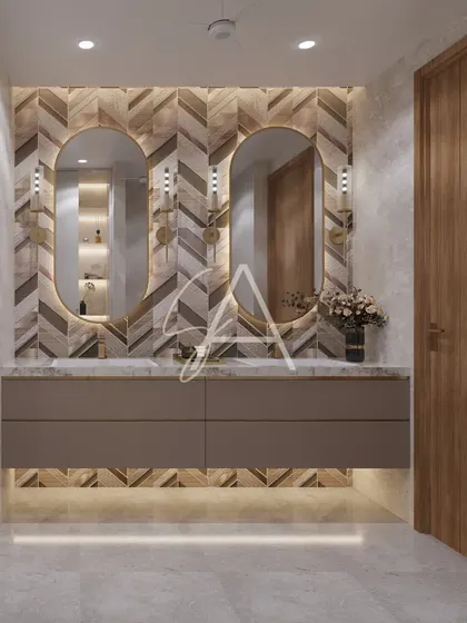 This master bathroom is all about opulence. I used a chevron-patterned tile with metallic accents as a feature wall behind the twin vanities, creating a space that feels both luxurious and dynamic.