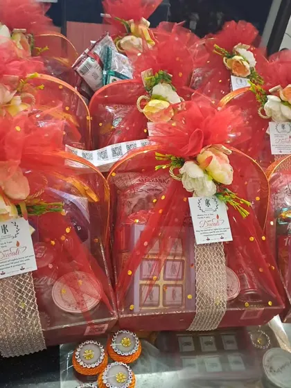 A collection of vibrant red wedding hampers. These are filled with chocolates and other goodies, and the custom tags make them perfect for either Diwali or wedding gifting.