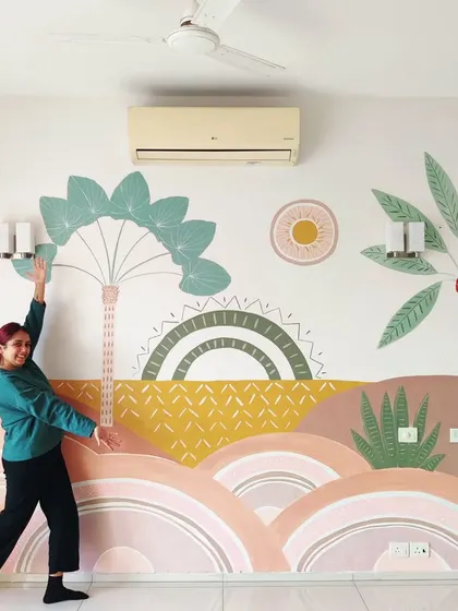The client happily posing with her new living room mural.