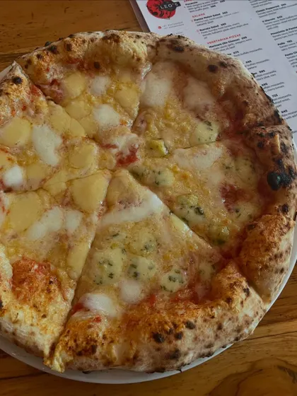 Dive into pizza perfection, one slice at a time with our Four Cheese pizza.