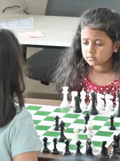 The deep concentration on a student's face as she plans her next move. Our camp is not just about learning rules; it's about developing focus, patience, and critical thinking skills.