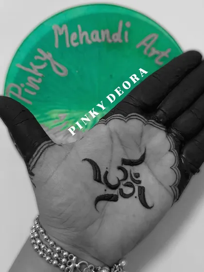 Chanting with art. A simple, bold, and powerful "Om" symbol etched in dark henna on the palm, representing the sound of the universe.
