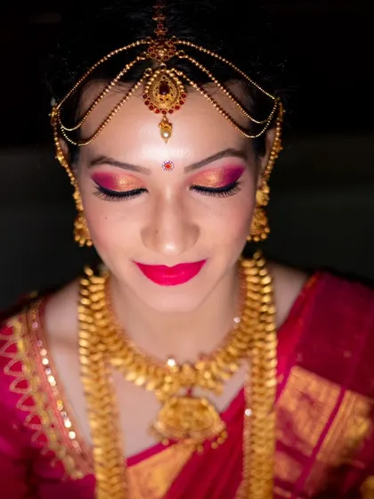 A close-up shot of the bride's stunning makeup and jewelry, highlighting the artistry involved.