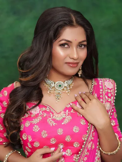 A close-up of a soft glam look with a pink lehenga, showcasing a radiant complexion and sparkling eyes.