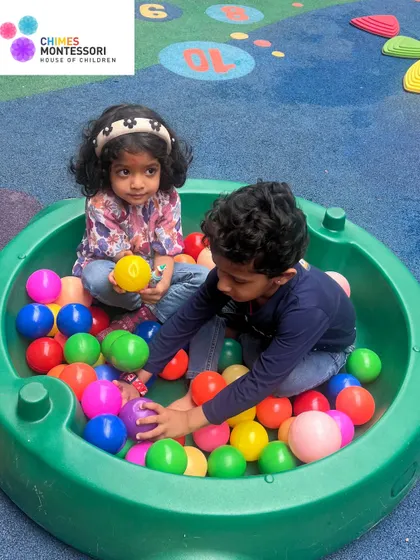Two children share a moment of fun in the ball pit. Our play areas are designed to encourage social interaction and cooperative play among our youngest learners.