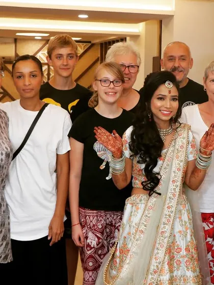 We love capturing moments with guests. Here, the bride poses with international guests, showing how weddings bring people together.