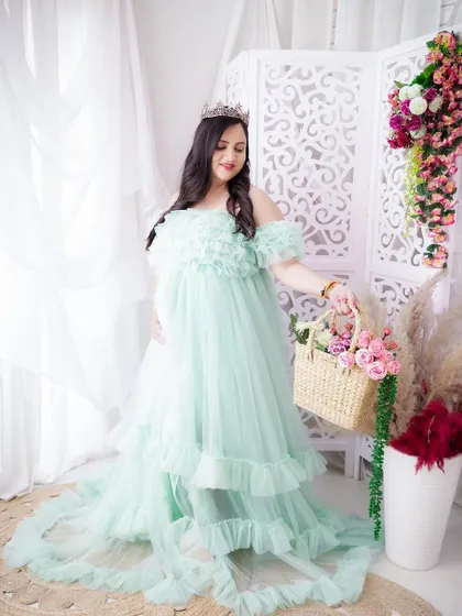 A duplicate of image 5, this fairytale portrait shows the mom-to-be in a mint green gown and tiara, looking absolutely radiant.