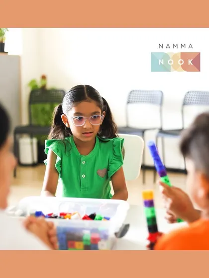 A young girl at one of my workshops, focused and curious as she interacts with the learning materials. My goal is to spark this kind of natural curiosity in every child.