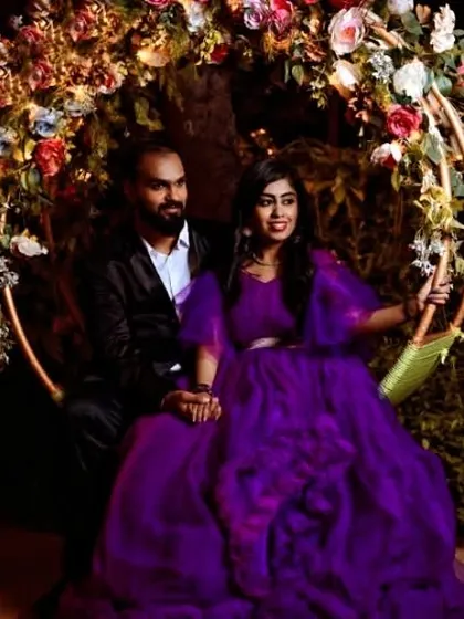 A whimsical shot on a floral swing. The flowing purple gown and romantic setting make for a perfect fairytale pre-wedding picture.