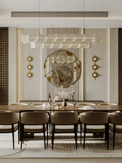 A grand and formal dining room with a long table perfect for hosting large gatherings. The intricate wall decor and statement chandelier create a very luxurious and impressive space.