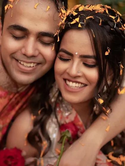 A sweet, candid moment of the couple during the Haldi ceremony, her makeup looking fresh and natural.