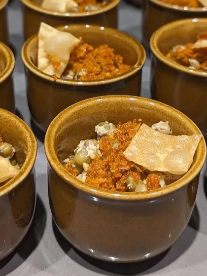 For catering events, I often serve tasting portions of my classic dishes, like this Kanji Payar. These small bowls allow guests to sample a variety of flavors without getting too full, making for a great start to a multi-course meal.