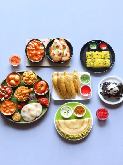 A collection of homemade classics in miniature form, including dosa, thali, brownie, naan, dhokla, and bhajiyas.