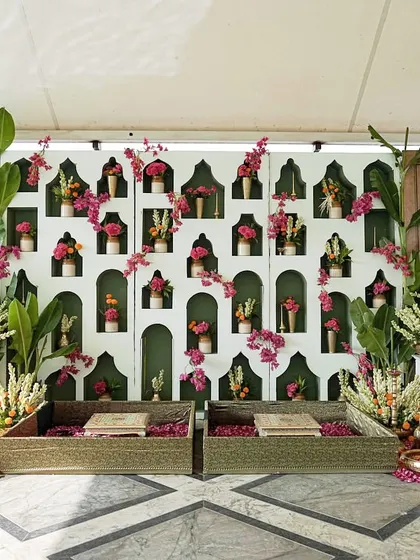 The complete setup for a Haldi ceremony inspired by a fusion of Kerala and Rajasthani cultures, featuring Pichwai art panels and traditional seating.