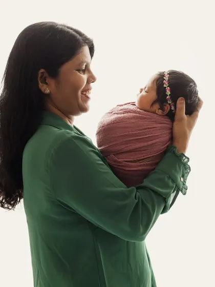 A grandmother's love. This heartwarming portrait shows a grandma holding her new grandchild, a beautiful image of generational connection.