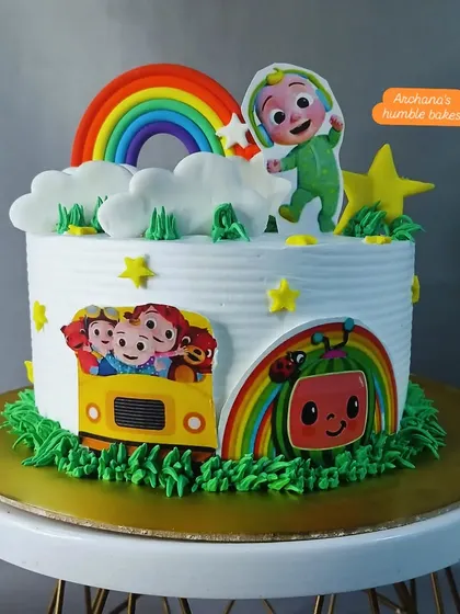 A single-tier Cocomelon cake with a big rainbow and the main characters, perfect for a smaller celebration.