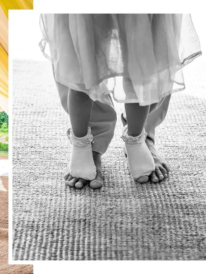 A detail shot of a little girl's feet standing on her mother's, a sweet moment from a family session.