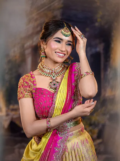 The model smiling brightly, looking happy and confident. This photo shows the versatility of my makeup for different festive occasions.