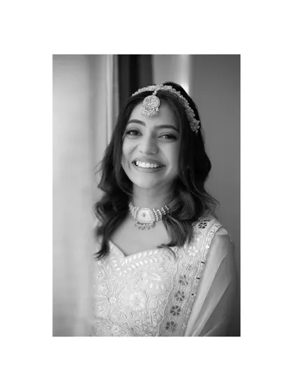 A simple and beautiful black and white portrait of a smiling bride, capturing her natural joy and radiance.