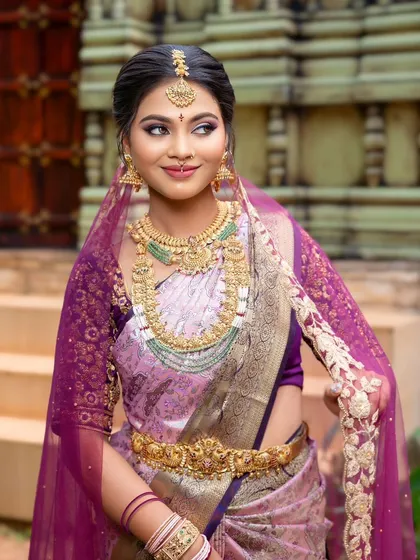 A three-quarter shot that captures the full effect of the jewellery with the vibrant saree.