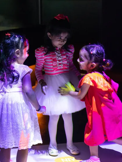 Friends gathering on the interactive floor, sharing a moment of wonder in our digital play zone.