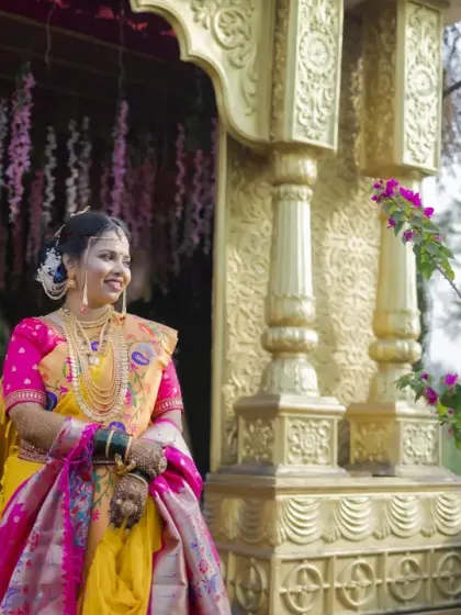 A wide shot of the bride at the wedding venue, capturing her full attire and the beautiful decor.
