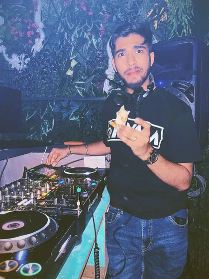 Another shot of me enjoying a snack during a gig. It shows the more relaxed and fun side of being a DJ.