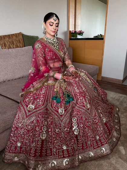 A full-length shot of the bride in her stunning JJ Valaya lehenga, her elegant bun completing the regal look.