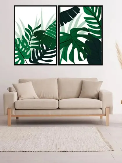 This set of two botanical art prints showcases the bold, graphic shapes of tropical leaves. The deep green colors create a lush, vibrant look that enlivens any living space.
