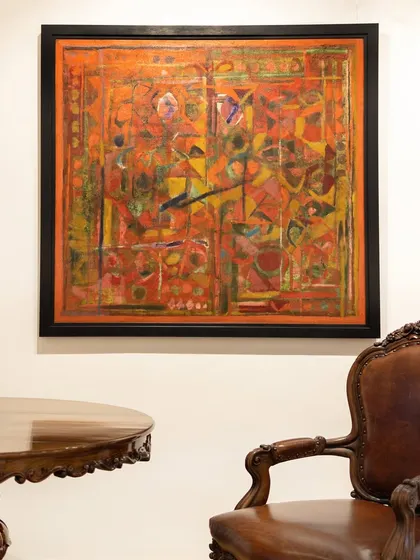'Untitled (Red)' from 1990 by Achutan Kudallur. A vivid interplay of vermilion, ochre, and green, layered in rhythmic formations that evoke ancient scripts. The textured depth creates a powerful sense of movement.