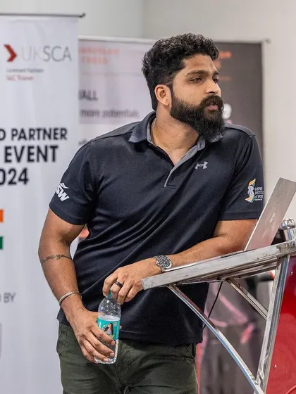 A speaker stands by the lectern at the 2024 UKSCA regional event, ready to share his expertise with the attendees.