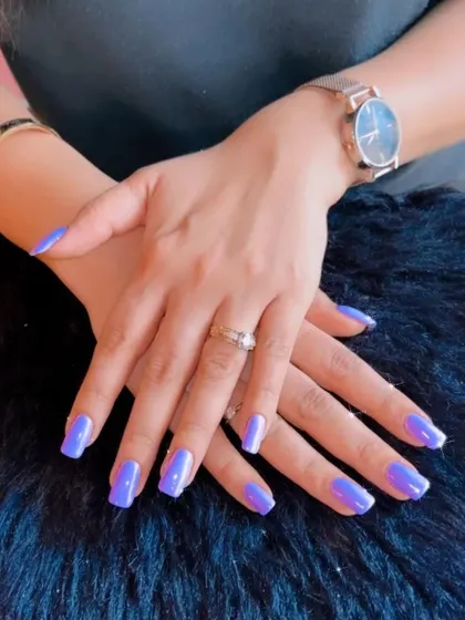 A vibrant and trendy periwinkle blue polish that makes a beautiful statement on these clean, square nails.